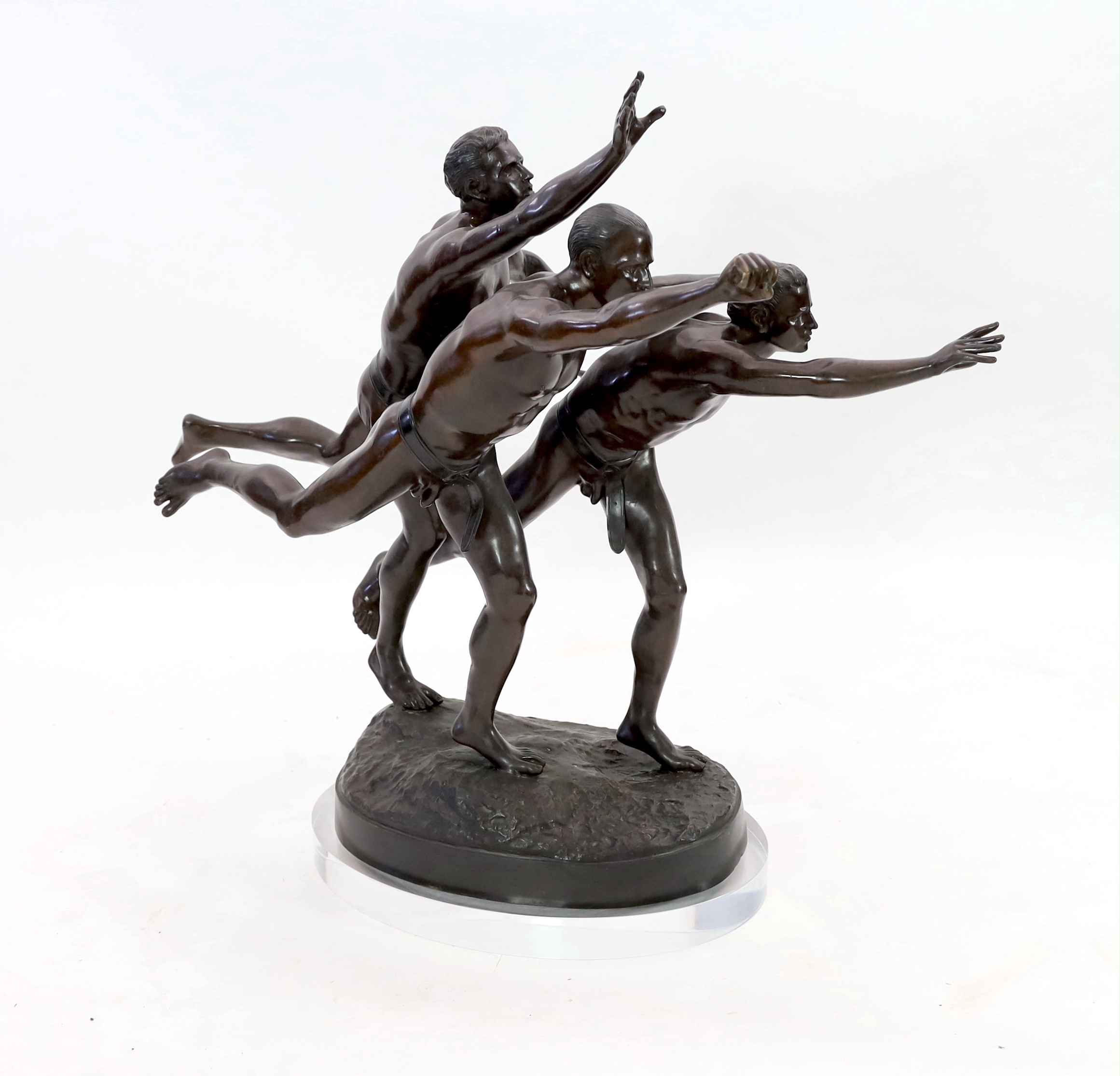 After Alfred Boucher (French, 1850-1934). A large bronze group of three runners at the finishing line, 'Au But', 128cm long, 78cm deep, 111cm high